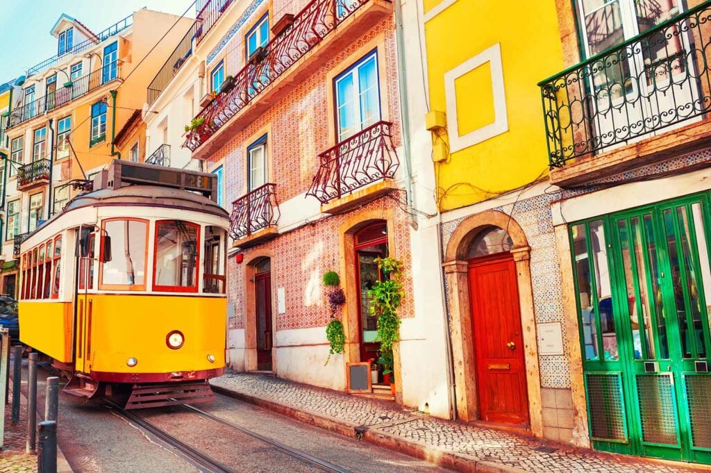 tram and colorful neighborhood in Lisbon.