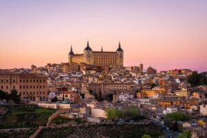 Panoramic view of Toledo with Alcazar castle at sunset,