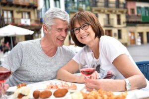 Senior couple enjoying spanish food in spanish restaurant.