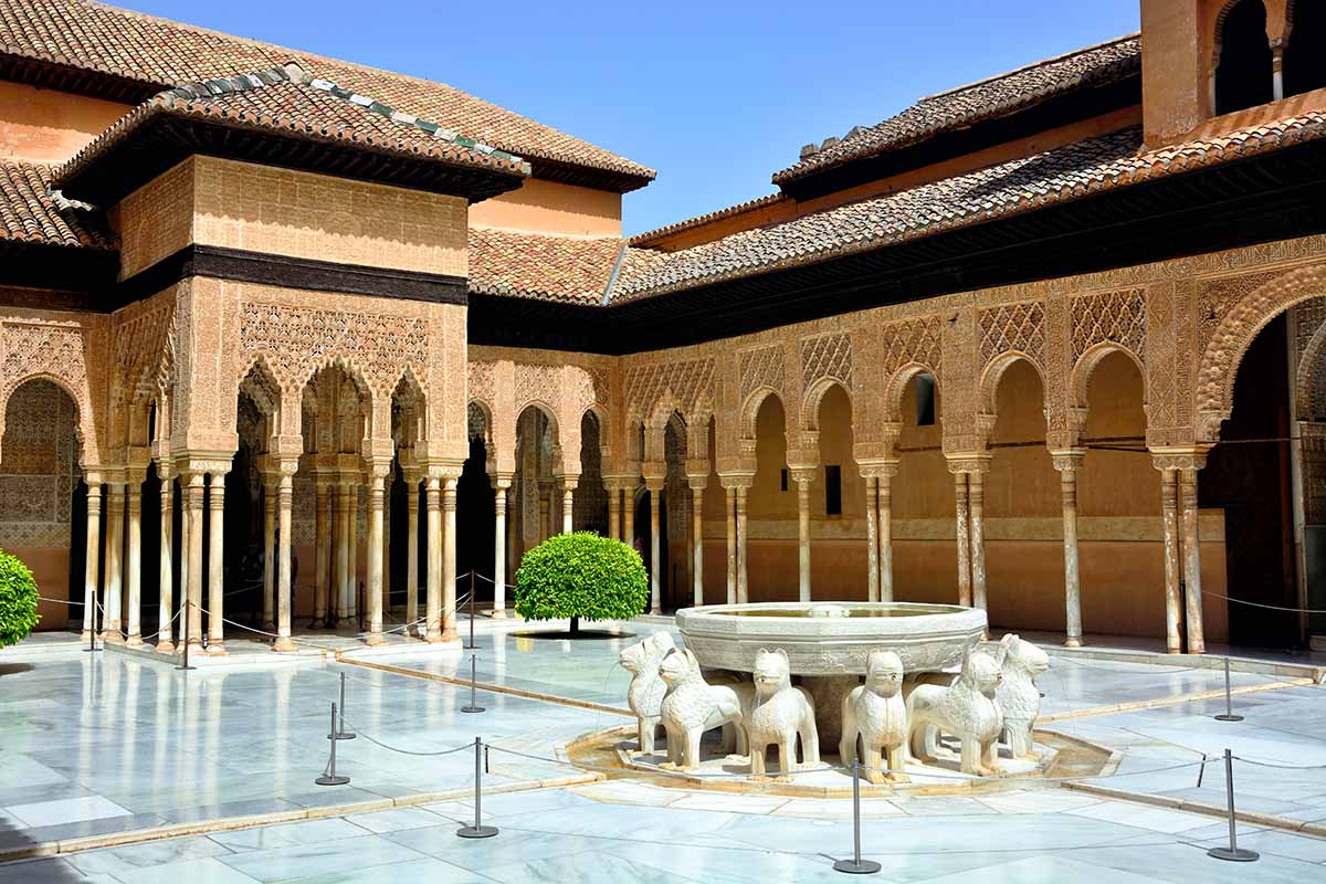 guided tour group at courtyard in Alhambra palace.