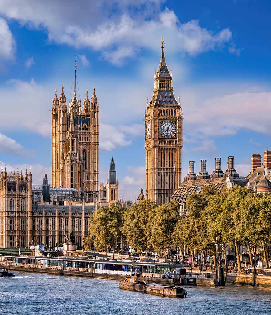 Big Ben and Houses of Parliament with boats on the river in London, England, UK