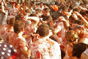 People throwing tomatoes at La Tomatina festival in Spain