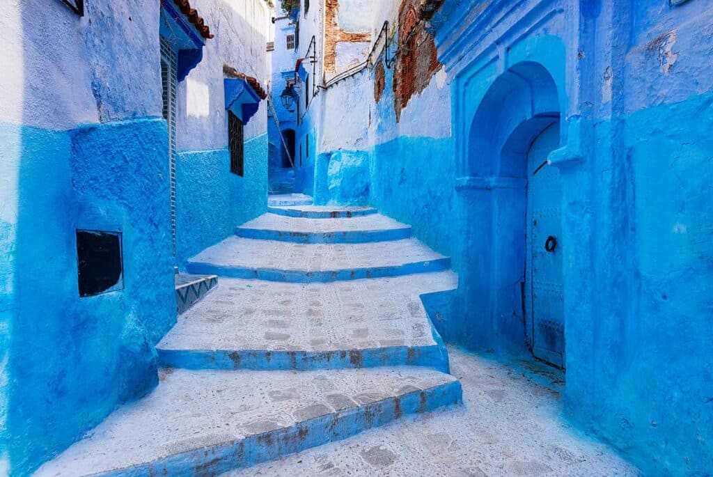 steps with blue houses on either side in town of Chefchaouen in Morocco